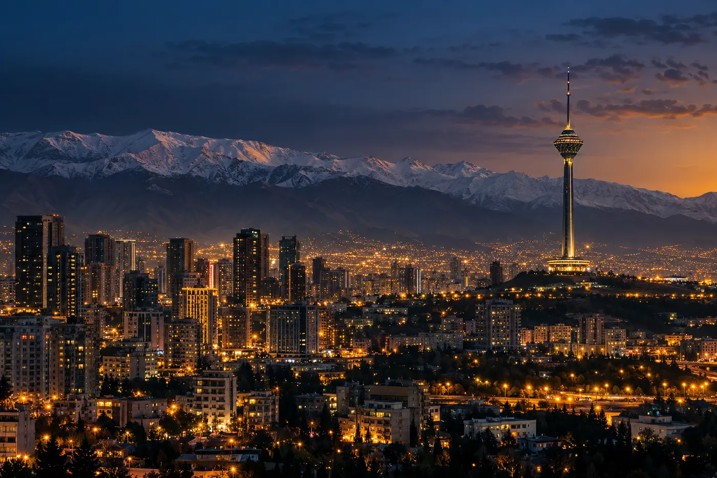 Tehran at dusk with the Milad Tower and the snow-capped Alborz mountains